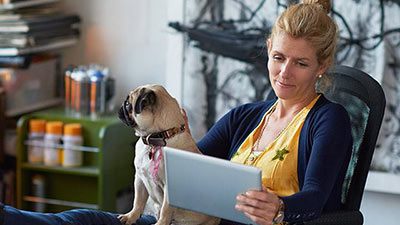 women using ipad with dog